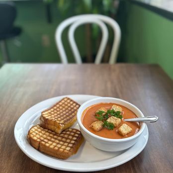 Leandro’s Cafe & Bistro - Warm tomato basil soup with croutons and fresh parsley, served with a classic grilled cheese for a simple and comforting bite. - Cafes Near Me - Wenatchee, Washington Leandro’s Cafe & Bistro - Warm tomato basil soup with croutons and fresh parsley, served with a classic grilled cheese for a simple and comforting bite. - Cafes Near Me - Wenatchee, Washington