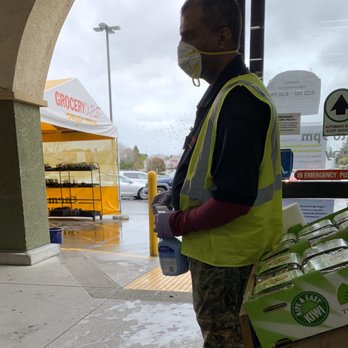 Grocery Outlet - Clerk wiping down carts before handing them to customers during COVID-19 Pandemic. Thank you! - Grocery Near Me - Richmond, California Grocery Outlet - Clerk wiping down carts before handing them to customers during COVID-19 Pandemic. Thank you! - Grocery Near Me - Richmond, California