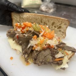 THE MANZO. Slow-braised shaved beef with sharp provolone, giardiniera, and au jus on the side.