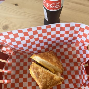 Little Ola's Biscuits - Sausage egg biscuit with a Mexican coke - Salad Near Me - Austin, Texas Little Ola's Biscuits - Sausage egg biscuit with a Mexican coke - Salad Near Me - Austin, Texas