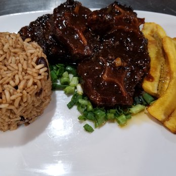 Irie Occasions - Oxtail with Rice and Beans with a side of plantains (typically served with Cabbage or Salad not pictured here). - Caterers Near Me - Detroit, Michigan Irie Occasions - Oxtail with Rice and Beans with a side of plantains (typically served with Cabbage or Salad not pictured here). - Caterers Near Me - Detroit, Michigan