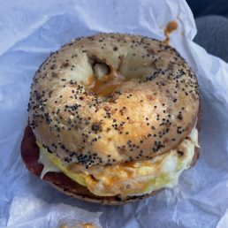 Everything bagel with bacon egg and cheese plus potatoes and chipotle mayo