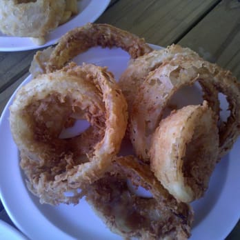 Stomp's Burger Joint - order of onion rings dripping with grease - Burgers Near Me - Bacliff, Texas Stomp's Burger Joint - order of onion rings dripping with grease - Burgers Near Me - Bacliff, Texas