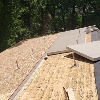 Roof Proofing - Polyiso closed cell insulating foam sheets on top of roof deck, with solar mounts. - Roofing Near Me