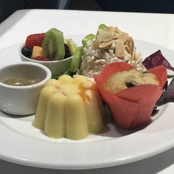 The Zodiac - Orange soufflé, chicken salad, fruit salad with poppy seed dressing and a mini blueberry muffin - New American Near Me - Dallas, Texas