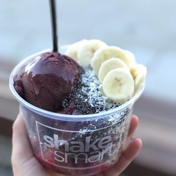 Shake Smart - a hand holding a cup of ice cream with bananas and chocolate - Juice Bars & Smoothies Near Me - San Marcos, Texas