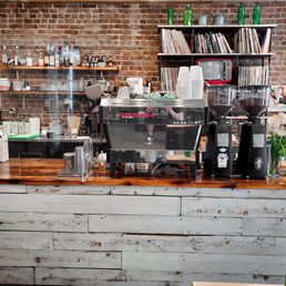 a brick wall and counter in a coffee shop a brick wall and counter in a coffee shop