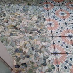 Magnolia Tile & Remodeling - Rock shower floor scribed into bathroom floor tile.