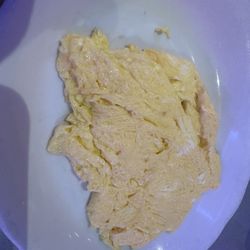 Scrambled eggs on separate plate for hungry man platter. Made perfectly.