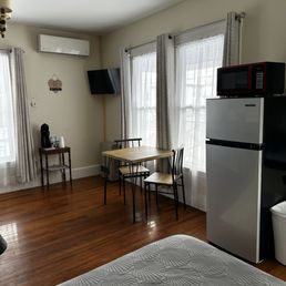 Cute seating area with apartment size fridge. Cute seating area with apartment size fridge.