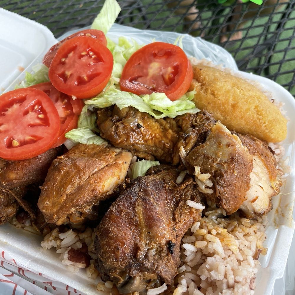 Chicken with rice and beans, small lettuce, salad, and a piece of cornbread