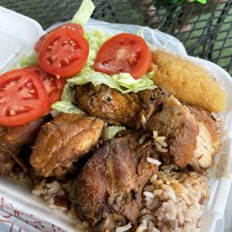 Chicken with rice and beans, small lettuce, salad, and a piece of cornbread Chicken with rice and beans, small lettuce, salad, and a piece of cornbread