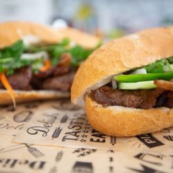 Vinh’s Banh Mi and Cafe - A crisp Vietnamese baguette filled with tender, smoky BBQ pork, pickled veggies, and fresh herbs.