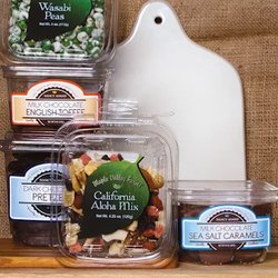 Nassau Candy - Assorted bulk nuts, dried fruit, and premium snack mixes in clear tubs, including wasabi peas, nut blends, chocolate pretzels...