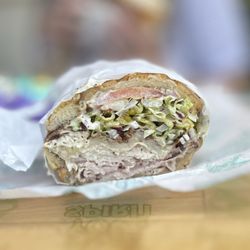Ghost Sando Shop - The Melrose: Dutch Crunch Roll w/Melrose spread, Black Forrest Ham, Oven Roasted Turkey, Bacon, White American Cheese, house slaw & tomato