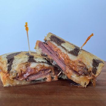 Opportunity Kitchen - a half eaten sandwich on a wooden table - Coffee & Tea Near Me - Richland, Washington