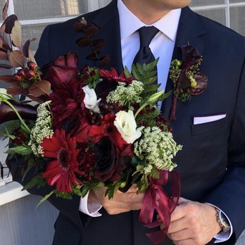 Mercado's Flowers - Groom (with boutonnière) holding a bridesmaid bouquet - Florists Near Me - Alhambra, California Mercado's Flowers - Groom (with boutonnière) holding a bridesmaid bouquet - Florists Near Me - Alhambra, California