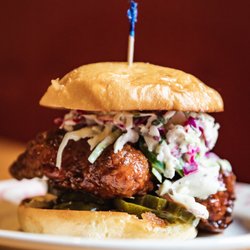 Midwood Smokehouse - Pollo texano! Honey chipotle tossed smoked fried chicken on angry pickles, apple jalapeño slaw and a brioche bun.