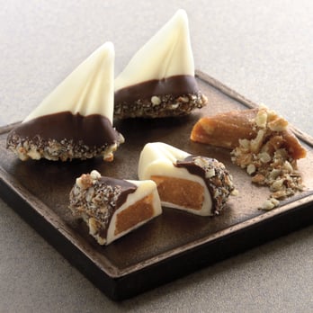 Harbor Sweets - Sweet Sloops are sailboat shaped almond buttercrunch toffee, a mainsail and jib of white chocolate floating in dark chocolate with pecans - Candy Stores Near Me - Salem, Massachusetts