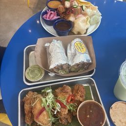 Sinigang wings, pork sisig burrito, lechon taco plate Sinigang wings, pork sisig burrito, lechon taco plate
