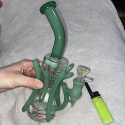 a hand holding a green pipe a hand holding a green pipe