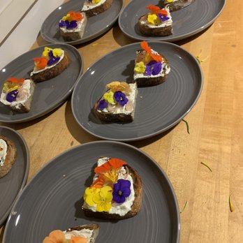Chef Eliot Ramirez - Herb ricotta, pickled onions, nasturtium flower on burnt sourdough - Personal Chefs Near Me Chef Eliot Ramirez - Herb ricotta, pickled onions, nasturtium flower on burnt sourdough - Personal Chefs Near Me