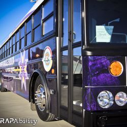 WrapAbility - Go big on the road! This white bus was designed, printed, and wrapped here.