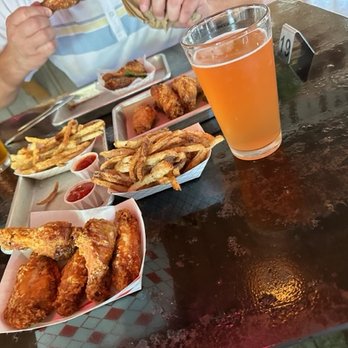 Cullum's Attagirl - Sal Y Limon chicken wings, Salt and Pepper fries, and Calisqueeze blood orange hefe. Across the table is Southern Fried. - Chicken Wings Near Me - San Antonio, Texas Cullum's Attagirl - Sal Y Limon chicken wings, Salt and Pepper fries, and Calisqueeze blood orange hefe. Across the table is Southern Fried. - Chicken Wings Near Me - San Antonio, Texas