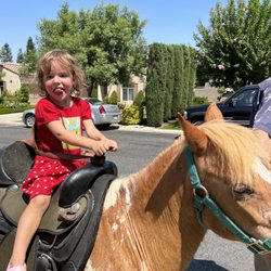 My daughter riding the pony