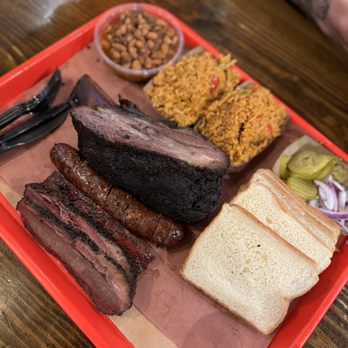 Terry Black's Barbecue - Rice, beans, pickles, 1 beef rib, original sausage, pork rib, 2 slices of brisket - Barbeque Near Me - Austin, Texas Terry Black's Barbecue - Rice, beans, pickles, 1 beef rib, original sausage, pork rib, 2 slices of brisket - Barbeque Near Me - Austin, Texas