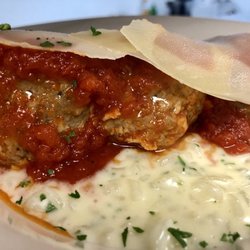 La Cucina Piccola - Homemade Meatballs over Creamy Risotto, topped with shaved Parmesan Cheese.