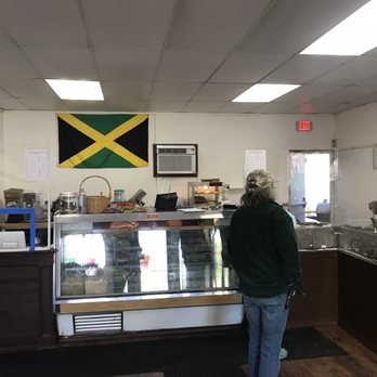 Grand Mango Caribbean Restaurant - a woman standing in front of the counter - Caribbean Near Me - Central Valley, New York