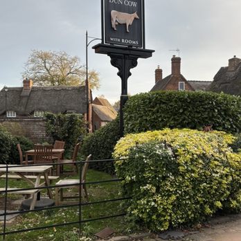 Dun Cow - The Dun Cow sign at the entrance to the parking lot. - Pubs Near Me - Rugby, WAR Dun Cow - The Dun Cow sign at the entrance to the parking lot. - Pubs Near Me - Rugby, WAR