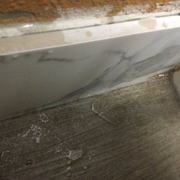 Dirt and dog hair in one corner in the bathroom