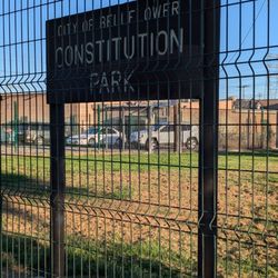 Constitution Park sign behind the fence