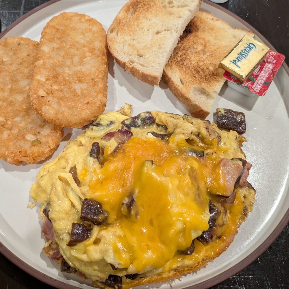 Meat omelette (your style) hash brown patties and sour dough toast. Meat omelette (your style) hash brown patties and sour dough toast.