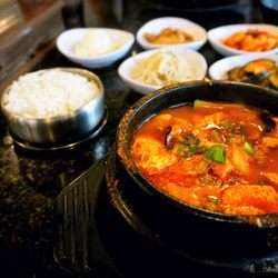 Pyung Chang Korean BBQ - Sundubu: spicy beef broth w/ silk tofu, vegetable, egg, choice of pork, seafood, veggie, or combo (+$1). Includes banchan and rice ($16.99).