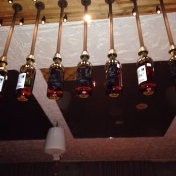 Big In Japan - Whiskey bottles hanging from the ceiling - Speakeasies Near Me - Montreal, Quebec