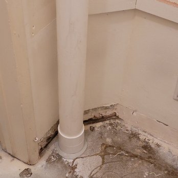 Radon Solutions - Sealed foundation core hole connected to PVC pipe to carry exhaust out of the house. - Environmental Testing Near Me
