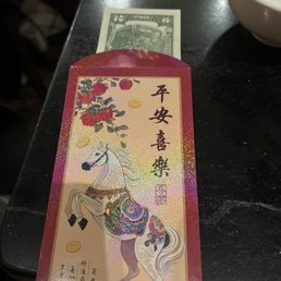 Red Envelope for Lunar New Year, with a lucky 2 dollar bill.