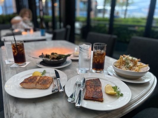 Photo of RH Rooftop Restaurant Columbus - Columbus, OH, US. Salmon with broccoli and truffle fries .