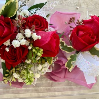 Carousel of Flowers - Matching corsage and boutonniere resting on a bed of rose petals. - Florists Near Me - Escondido, California Carousel of Flowers - Matching corsage and boutonniere resting on a bed of rose petals. - Florists Near Me - Escondido, California