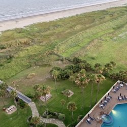 The Galvestonian - View from our rental on 12th floor. You can see part of the pool, and the deck walkover to the beach