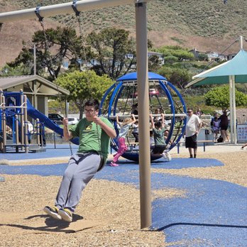Dinosaur Caves Park - Swings and cool spinning thing in the background - Parks Near Me - Pismo Beach, California