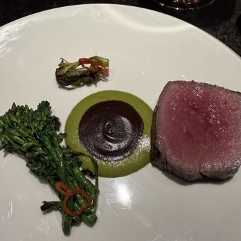 Emelina - 45 day aged strip with green mango and black bean purées and broccolini - Cuban Near Me - West Palm Beach, Florida Emelina - 45 day aged strip with green mango and black bean purées and broccolini - Cuban Near Me - West Palm Beach, Florida