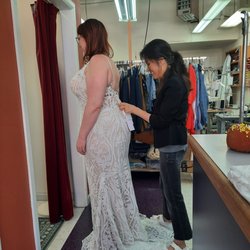 Superb Custom Tailors - At Superb Custom Tailors, Misook one of the owner helping her customer with a smile