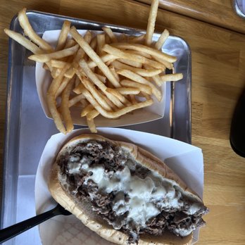 Famous Philly’s Cheesesteak Grill - a plate of fries and a sandwich - Cheesesteaks Near Me - Daytona Beach, Florida Famous Philly’s Cheesesteak Grill - a plate of fries and a sandwich - Cheesesteaks Near Me - Daytona Beach, Florida
