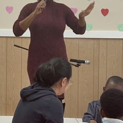 Seven Oaks Academy - Head of School, Executive Director Mrs. Gwyn speaks to the children and guest about the importance of showing love on Valentine's Day!