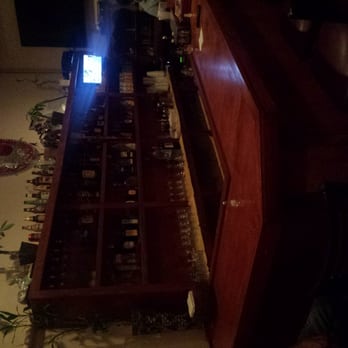 La Villa Restaurant - a bar with bottles of wine - Mexican Near Me - Washington, DC, District of Columbia