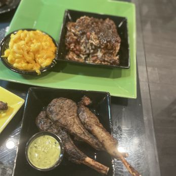Cutlass Grille - Appetizer:lamb chops and sides rice/pease and oxtail sauce. Mac and cheese - Caribbean Near Me - Chesapeake, Virginia Cutlass Grille - Appetizer:lamb chops and sides rice/pease and oxtail sauce. Mac and cheese - Caribbean Near Me - Chesapeake, Virginia